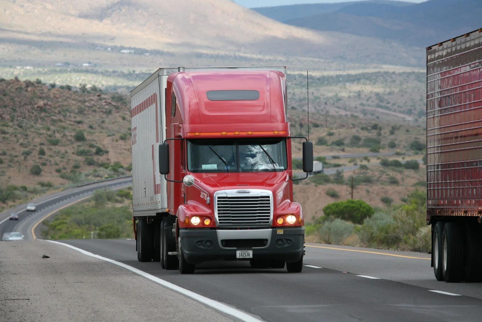 Freightliner semi-truck on a US highway, representing Orynlo services