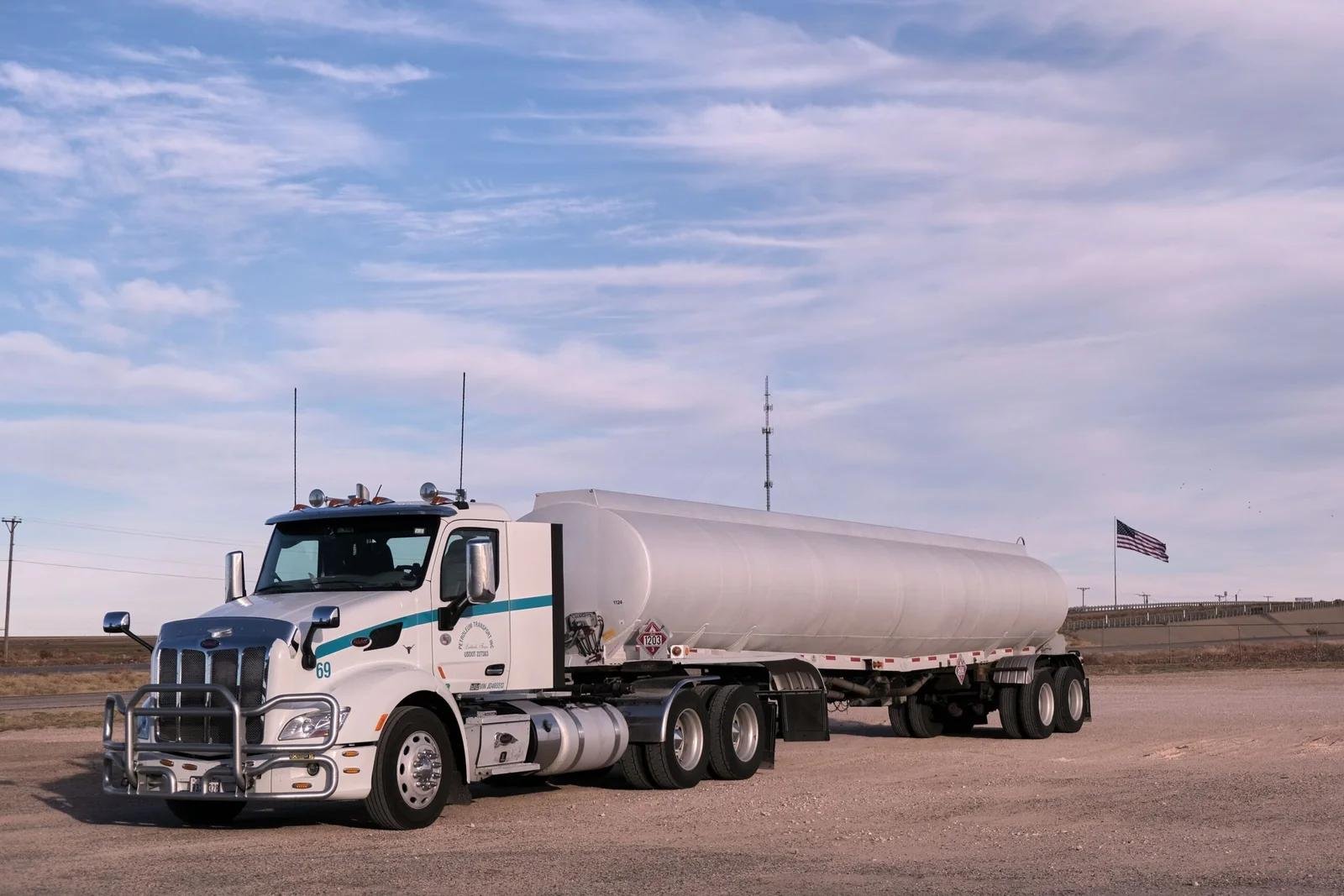 Tanker truck with American flag, representing carrier dispatch services